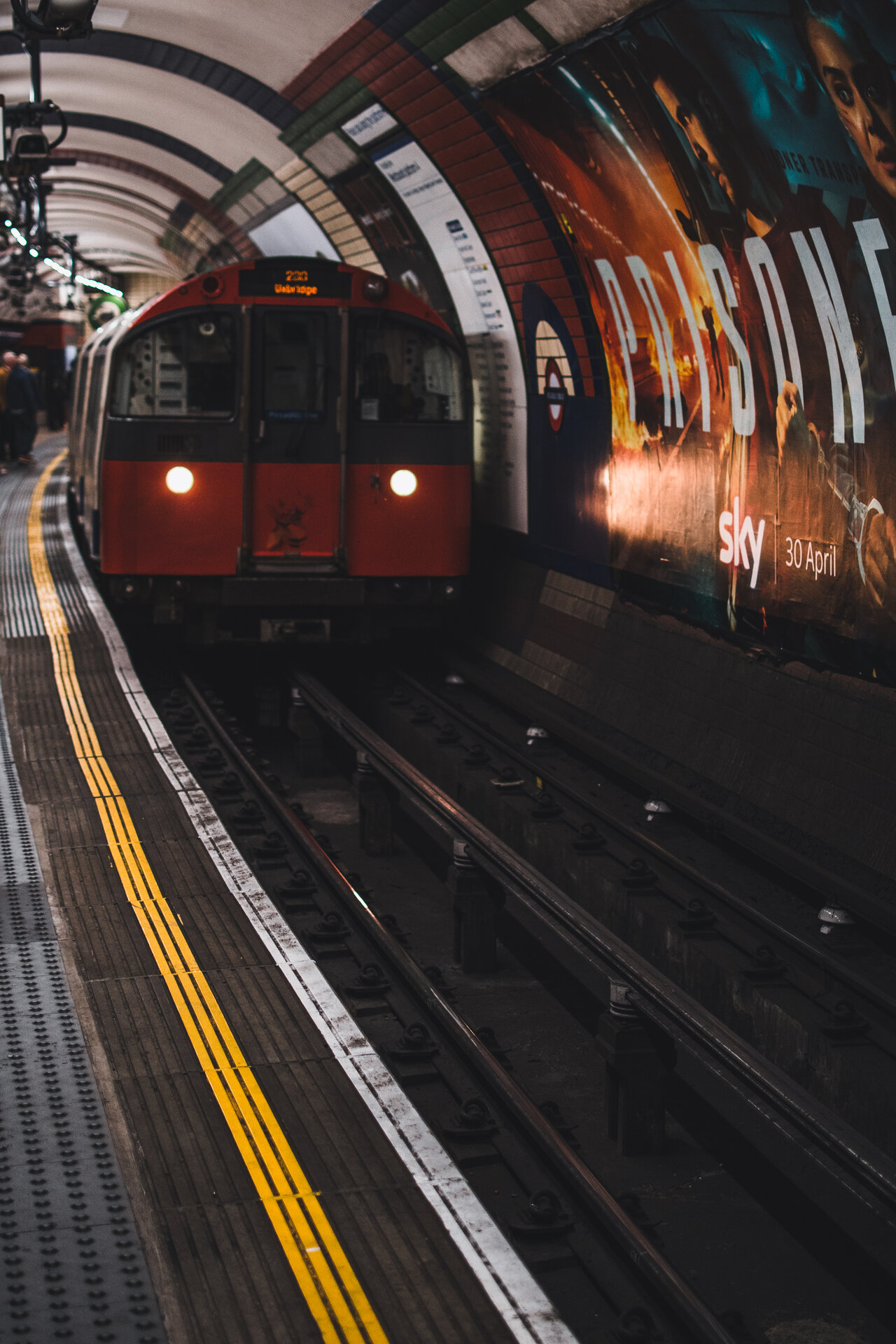 London Underground train entering station, motion blur on yellow lines