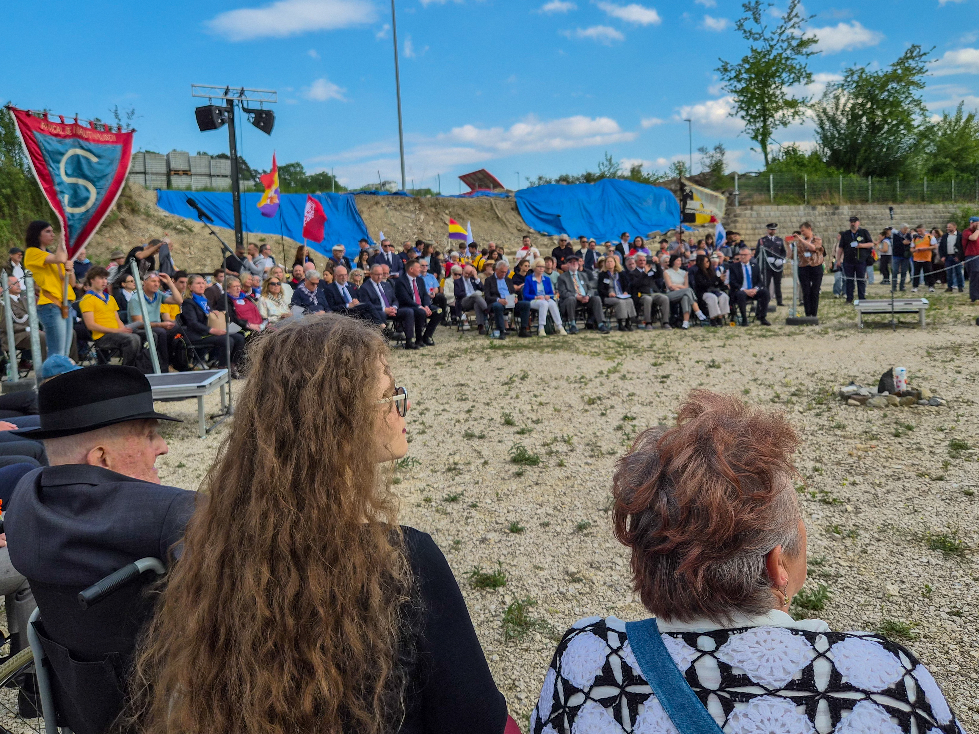 Ceremony crowd gathered on the former Gusen roll-call ground, Stanislaw Zalewski visible at left in wheelchair