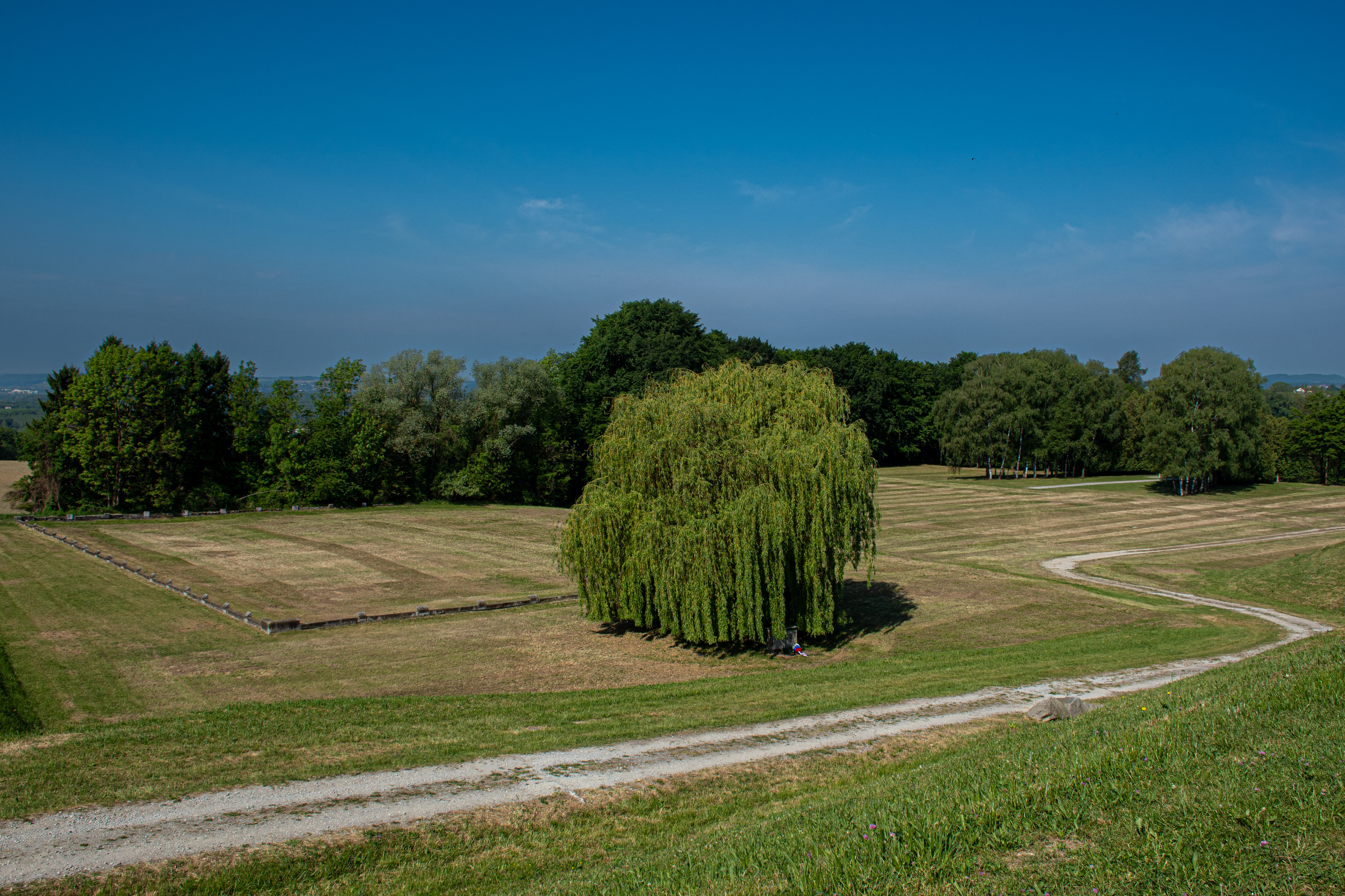 The soccer pitch outside the Mauthausen camp gates with overflow barracks visible