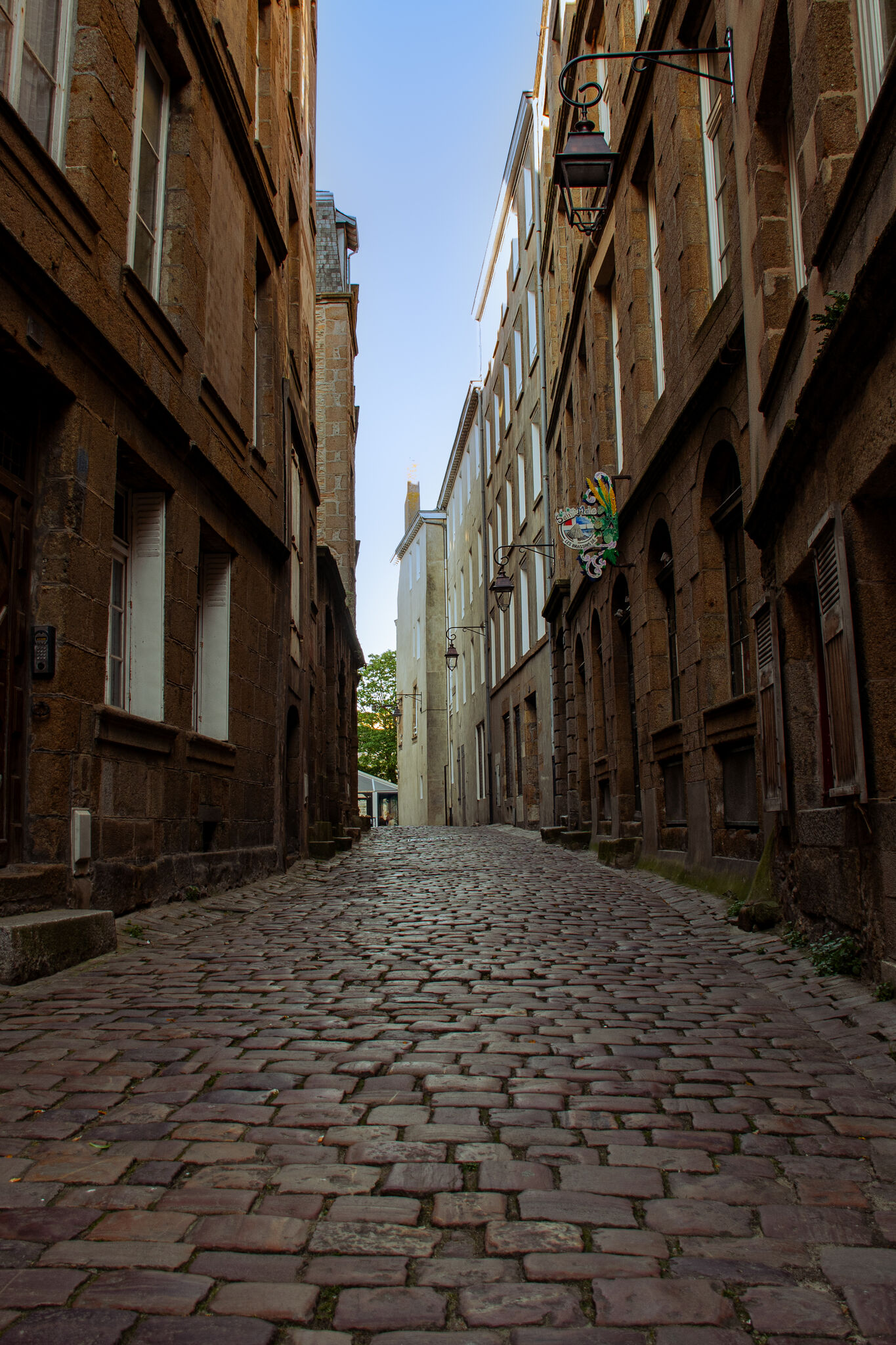 Wide cobblestone lane in the inner city, empty in the early morning light