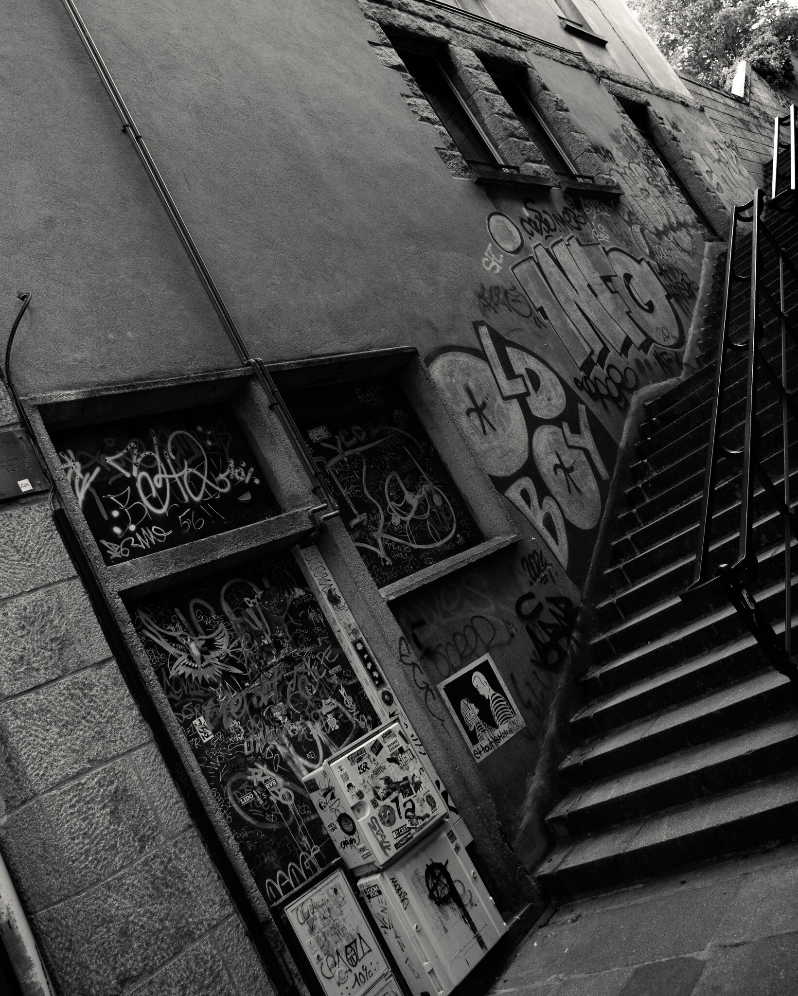 Graffiti-covered wall and staircase in a corner of the inner city, black and white